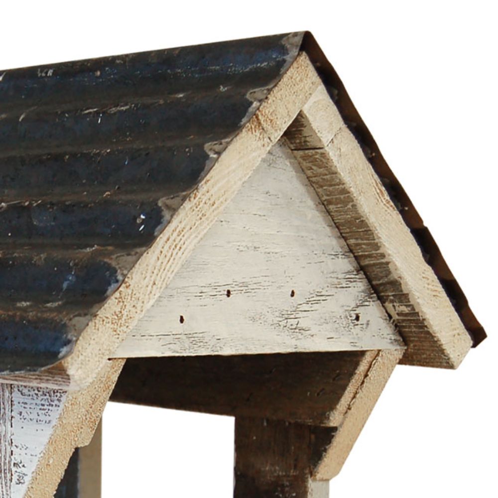 Close-up of a rustic A-frame roof structure with distressed dark blue-gray shingles and weathered light wood beams on a white background

perch & weather